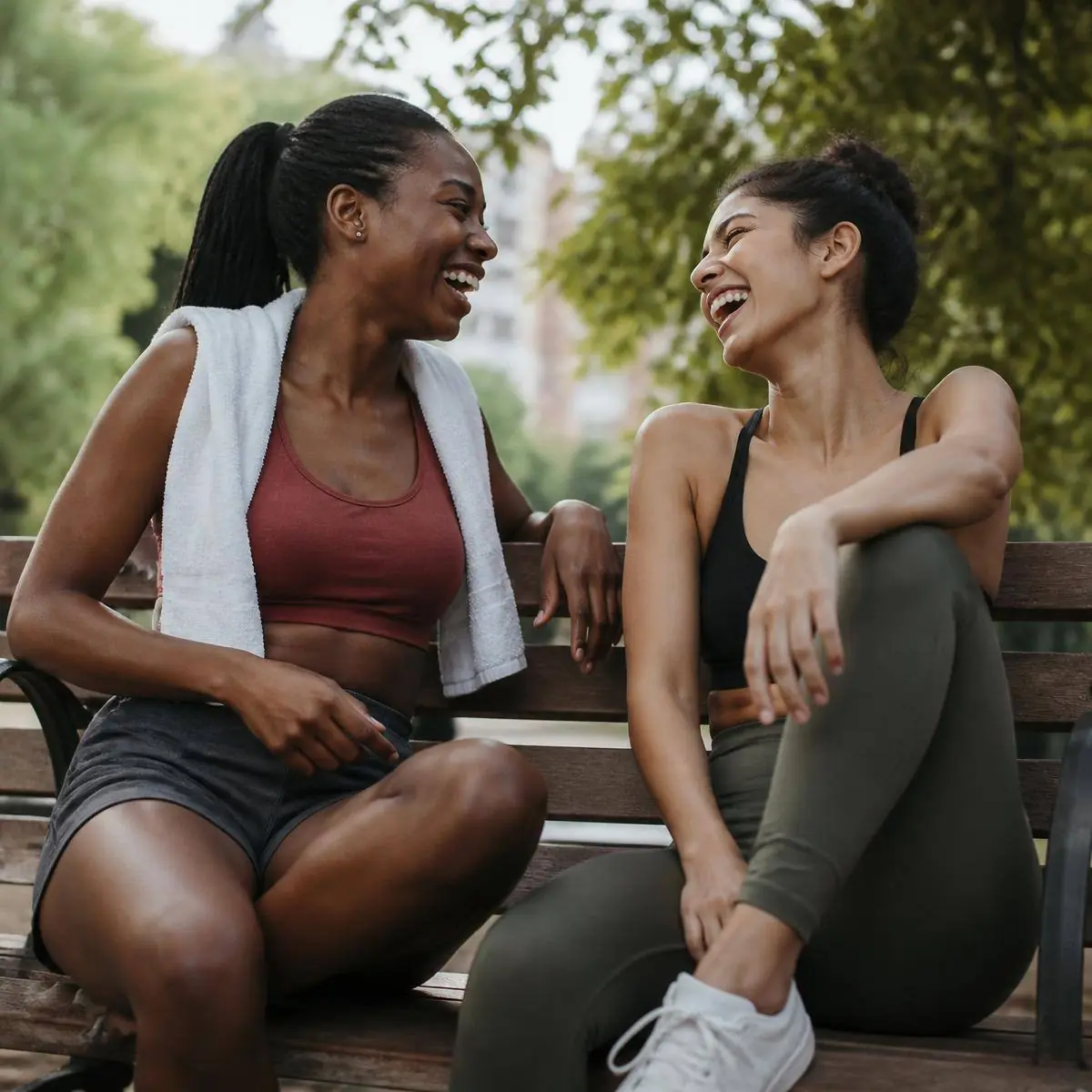 Two friends laughing after a workout